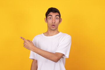 young teenager man pointing isolated on color background