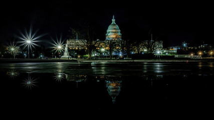 Fototapeta na wymiar The capitol in Washington D.C., United States of America at a cold night in spring with reflections in water.