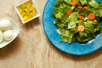 Salad on a Blue Plate Eggs and Sliced Peppers in White Bowls
