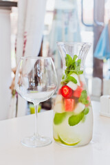 Cold fruit drink with a glass on a white background