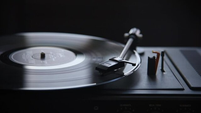 Music playing on retro vinyl gramophone.
