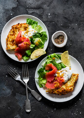 Potato roasted tortilla with greek yogurt, smoked salmon and green salad on dark background, top view. Delicious breakfast, appetizer, tapas