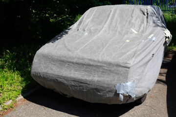 A car hidden under the tarpaulin