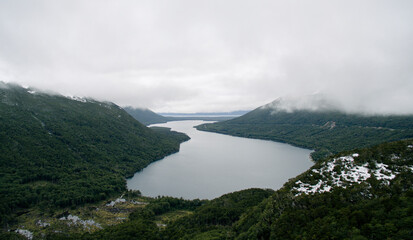 Panorama aerial view of Lake Fagnano surrounded by forest and the Andes mountains in Tierra del Fuego, Patagonia Argentina