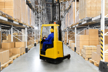 Fototapeta na wymiar A large distribution warehouse with yellow forklift