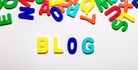 The word BLOG is made up of multi-colored letters on a light background
