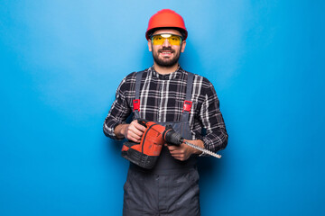 Repair, construction and building. Young male worker or builder with working with electric drill or...