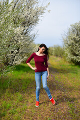 Brown hair girl in sunglasses on the flower meadow