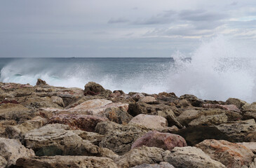 huge mass of water hit a rocky cliff. The crazy Mediterranean sea rustles and attacks all the rocks and wants to get out of his home. Salt water explosion. Crashed. Cyprus island