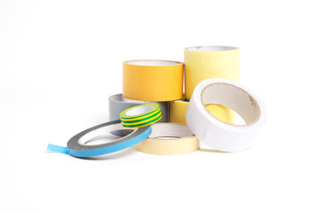 A heap of packing tape and a masking tape isolated on white background, with clipping path. adhesive tape. Scotch tape.

