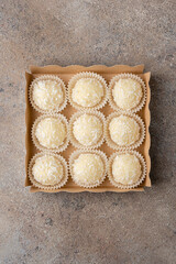 Set of coconut truffles made of white chocolate, cream and coconut.