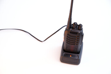 portable radio Walkie-talkie on charging station, isolated on white background 