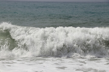 Splash of sea water after hitting a rocky cliff in southwestern Cyprus near the town of Paphos. Stormy and dangerous situation. Huge masses of water. Avalanche sea. Flood is coming