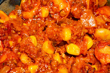 Quesadilla filling with ground beef, sausage, red beans, sweet corn, onion and tomato sauce. A traditional Mexican dish. Close up.