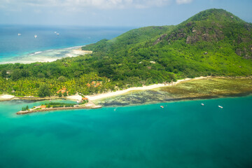 Naklejka premium Beautiful tropical seascape with crystal clear sea water turquoise color sand blue sky. aerial view. Tropical background scenic.