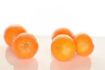 Bright yellow juicy, fresh, organic tangerines, close-up, on a white background.