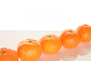 Bright yellow juicy, fresh, organic tangerines, close-up, on a white background.