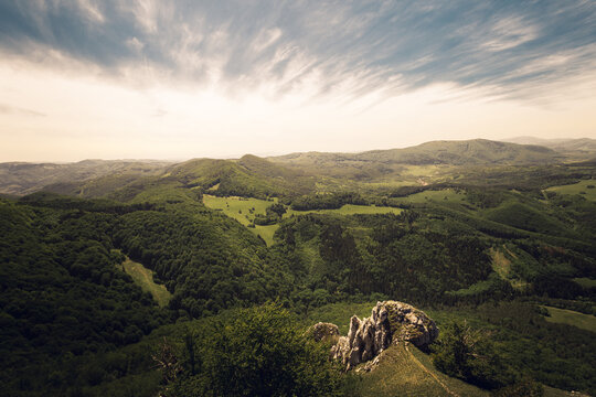 Beautiful scenic view of valley and big hills (mountains) in Slovakia on sunset with cloudy sky. Perfect panorama view on meadow and hills on sunset - summertime photo. Hills of Vapec - Slovakia.