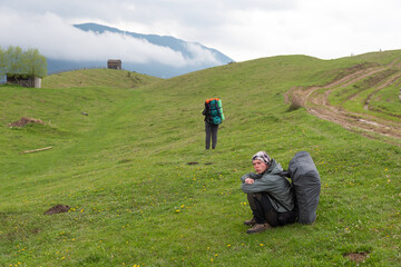 Fototapeta premium two friends of a tourist on a hike one is waiting for the other