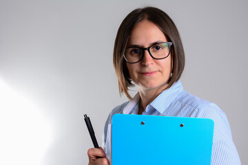 Business woman with clipboard. young attractive business woman with pencil and clipboard isolated on grey background. Happy beautiful business woman with clipboard