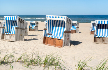 Beach chairs on the sand at the North Sea on Sylt island. Summer vacation