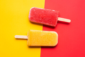 Ice cream popsicles top view. Mango and strawberry icecream