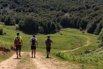 varias personas caminan por senderos en el monte gorbea en un dia soleado con pocas nubes y caminos de piedras , vistas a la monta&ntilde;a