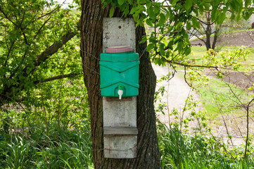 Vintage rustic washbasin by the tree in summer