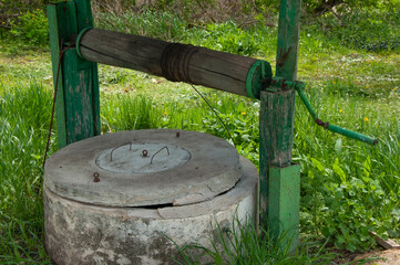 Old vintage well in the village in summer