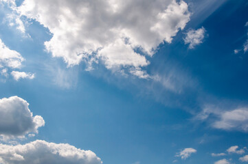 Naklejka na ściany i meble White clouds on a blue sky. Beautiful natural background