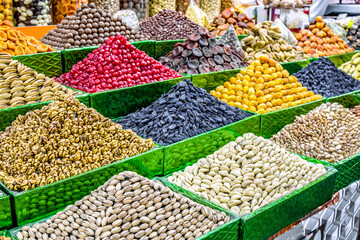 Dried fruits and nuts for sale on a market counter.