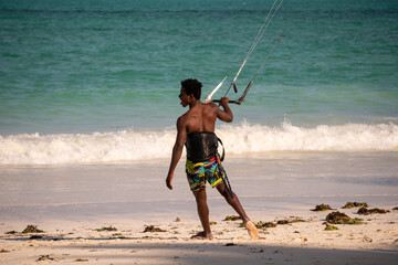 Young Attractive Muscular and Strong Athletic Black African Man Kite Surfing Instructor Teacher at the White Sand Beach