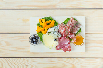 Antipasto Platter Cold Meat Plate with Cheese on Wooden Background