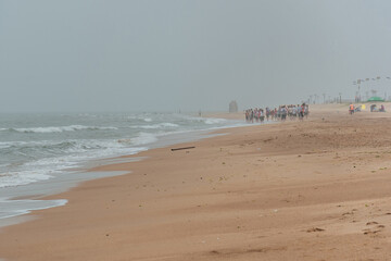 Fototapeta na wymiar Sand by the sea against a foggy sky