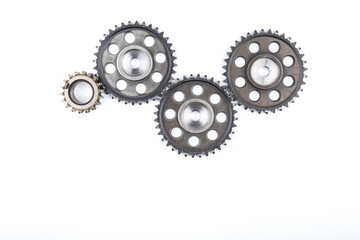 mechanism of cogwheels on a white background. concept of teamwork. several gears on a white...