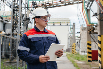 The energy engineer inspects the equipment of the substation. Power engineering. Industry