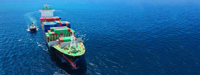Fototapeta premium Aerial drone ultra wide photo of fully loaded container cargo ship cruising in open ocean deep blue sea