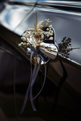 The handle of the wedding car in the scenery. Wedding decorations and floristics. Floristics and decor