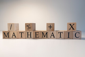 Mathematics, astronomy, economy words with letters from wooden cubes