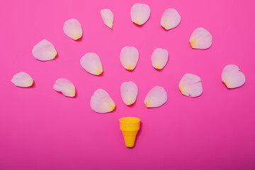 Summer minimal concept. Ice cream cone with rose leaves on punchy pastel background. Flat lay. Top view. Creative layout.