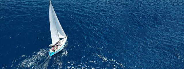 Aerial drone ultra wide photo of beautiful sail boat with white sails  sailing open ocean deep blue...