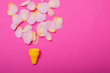 Summer minimal concept. Ice cream cone with rose leaves on punchy pastel background. Flat lay. Top view. Creative layout.
