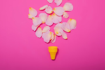 Summer minimal concept. Ice cream cone with rose leaves on punchy pastel background. Flat lay. Top view. Creative layout.