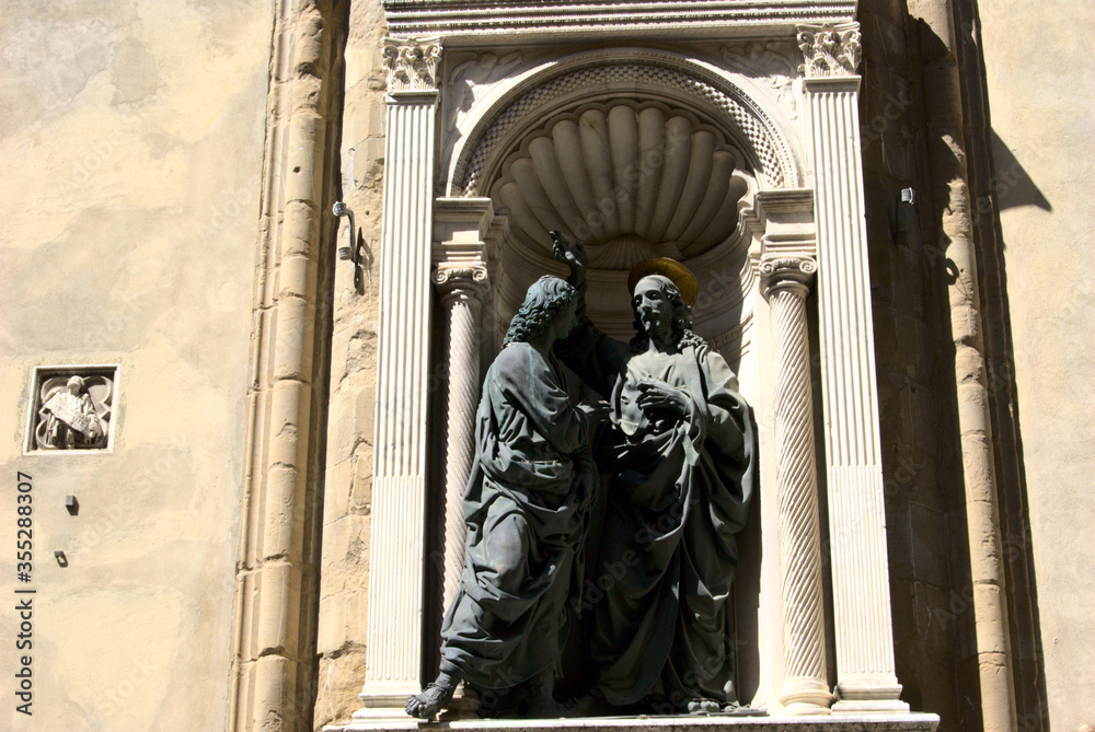 Wall mural Christ and St. Thomas, a bronze sculpture made by Andrea del Verrocchio and placed outside Orsanmichele church in Florence, Italy