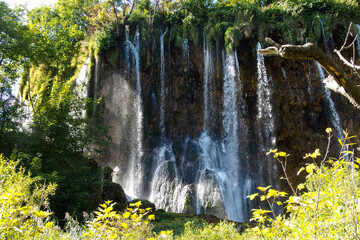 Landscape of waterfall and turquoise lake in the forest. Plitvice Lakes National Park. Nacionalni park Plitvicka Jezera, one of the oldest and largest national parks in Croatia. UNESCO World Heritage.