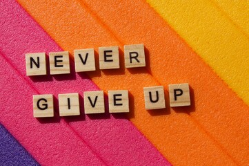 Words written on wooden blocks. Colorful background. Never give up. Motivational message. Words and phrases. Never give up writing. Positive background