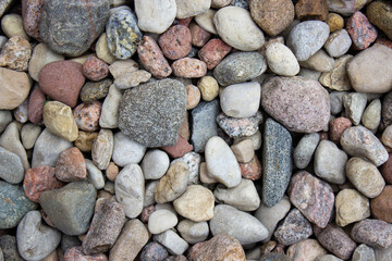 Many stones of various shapes and sizes on the earth. Background of stones.