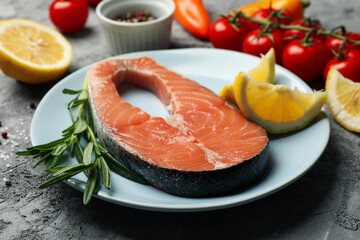 Composition with salmon meat and ingredients on gray background, close up