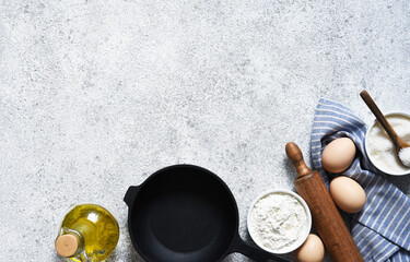 Baking background with flour, wheat ears and rolling pinon concrete background. Top view with copy space.