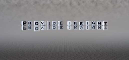 provide insight concept represented by black and white letter cubes on a grey horizon background stretching to infinity